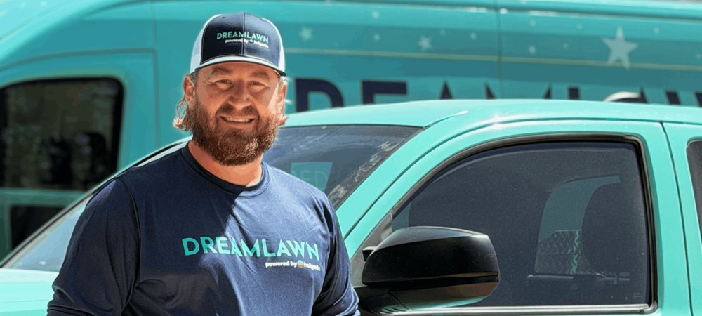 Aaron in front of a DreamLawn truck